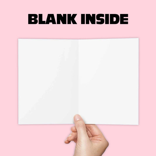 Hand holding a blank inside page of a Golden Pixel Studio cheeky holiday greeting card on pink background